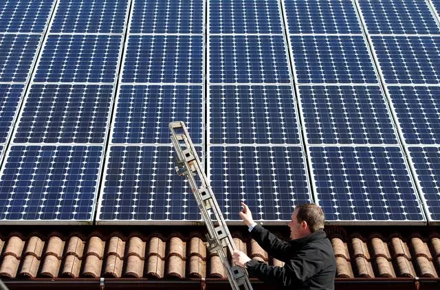 michael greif controls his 56 photovoltaic solar panels at the roof of his house in coburg march 5 2013 photo reuters michael greif controls his 56 photovoltaic solar panels at the roof of his house in coburg march 5 2013 photo reuters