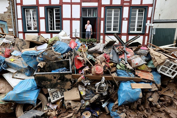 a man looks on outside a house in an area affected by floods caused by heavy rainfalls in bad muenstereifel germany photo reuters