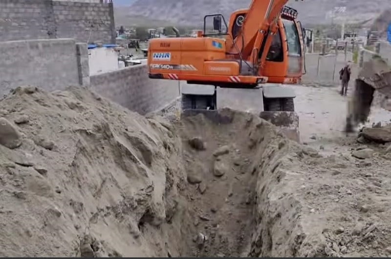 An excavator digs a passage for Gilgit's sewerage and sanitation project. PHOTO: EXPRESS
