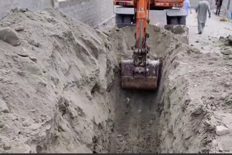 An excavator digs a passage so pipes to be laid for Gilgit's sewerage and sanitation project. PHOTO: EXPRESS