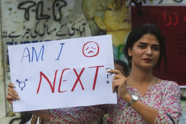 a protestor is seen holding a placard in karachi during a protest against the motorway rape photo afp