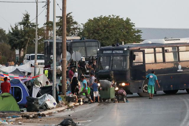 police block an area where refugees and migrants from the destroyed moria camp are sheltered during an operation to move them in a new temporary camp on the island of lesbos greece september 17 2020 photo reuters