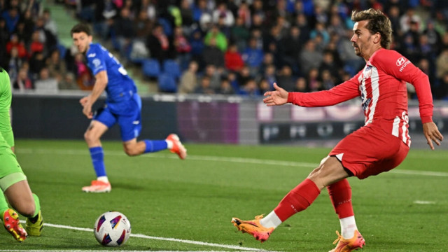 five star atletico madrid forward antoine griezmann netted a hat trick as his side thrashed getafe to secure champions league football photo afp five star atletico madrid forward antoine griezmann netted a hat trick as his side thrashed getafe to secure champions league football photo afp