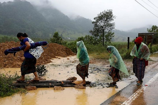 women walk at an area affected by a mudslide after the passage of storm eta in purulha baja verapaz guatemala november 6 2020 photo reuters women walk at an area affected by a mudslide after the passage of storm eta in purulha baja verapaz guatemala november 6 2020 photo reuters