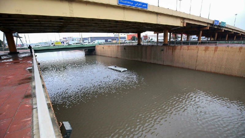 A bus is engulfed on a flooded road in Kuwait City following torrential rain. PHOTO: AFP