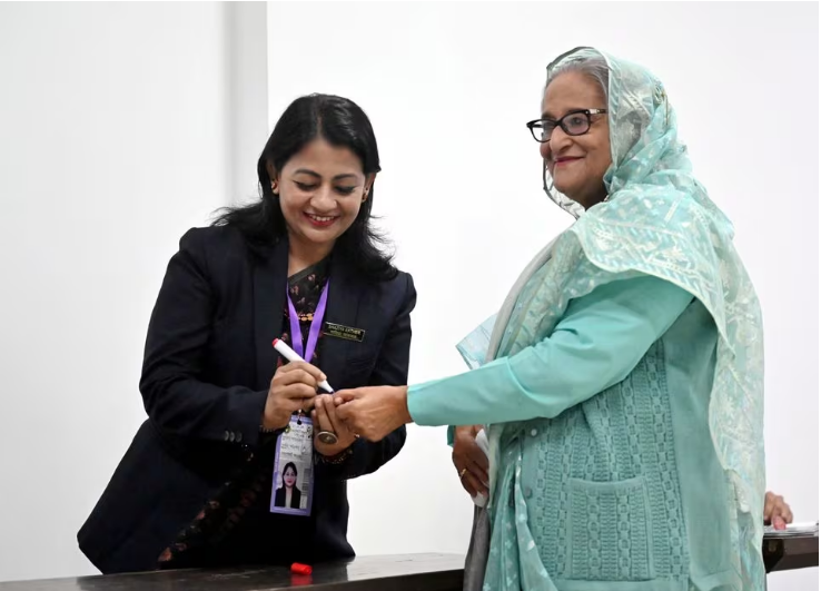 an officer puts an ink mark on the thumb of sheikh hasina prime minister of bangladesh and chairperson of bangladesh awami league at the dhaka city college center during the 12th general election in dhaka bangladesh january 7 2024 photo reuters