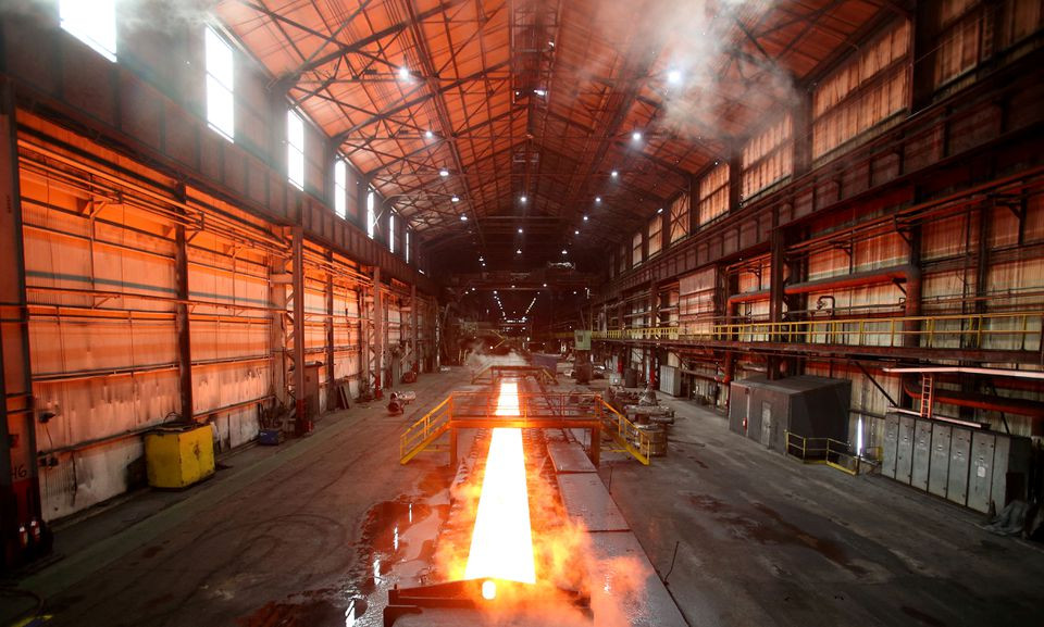 steam rolls off a slab of steel as it rolls down the line at the novolipetsk steel pao steel mill in farrell pennsylvania us photo reuters