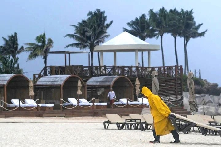 a beach worker moving things amid high alert of helen storm photo reuters