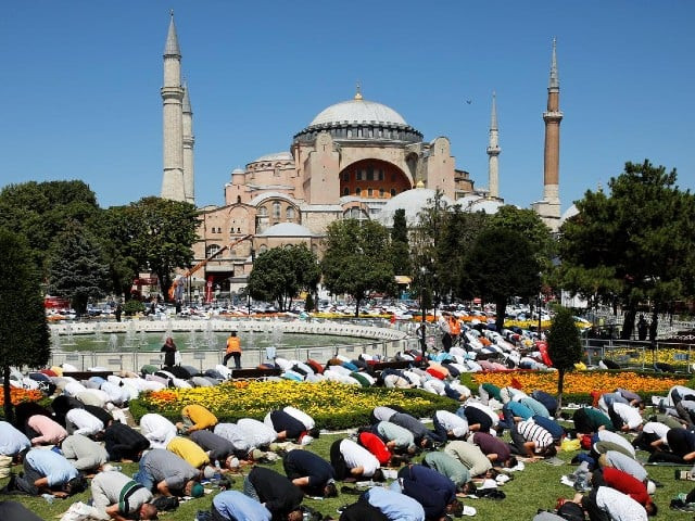 muslims attend friday prayers outside hagia sophia grand mosque for the first time after it was once again declared a mosque after 86 years in istanbul turkey july 24 2020 photo reuters