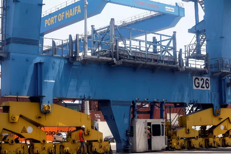 port workers wait for trucks to arrive and take containers from cargo ships while it is docked at the port of haifa israel august 8 2021 photo reuters port workers wait for trucks to arrive and take containers from cargo ships while it is docked at the port of haifa israel august 8 2021 photo reuters