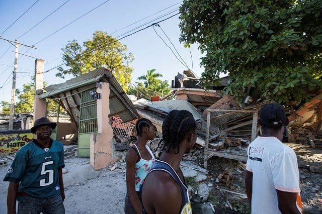 people walk past a house destroyed following a 7 2 magnitude earthquake in les cayes haiti august 14 2021 photo reuters people walk past a house destroyed following a 7 2 magnitude earthquake in les cayes haiti august 14 2021 photo reuters