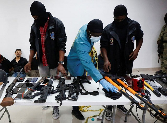 weaponry mobile phones passports and other items are being shown to the media along with suspects in the assassination of president jovenel moise who was shot dead early wednesday at his home in port au prince haiti july 8 2021 photo reuters