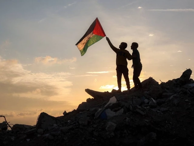 a boy runs with a palestinian flag atop a mound of rubble at a camp in bureij central gaza strip on friday photo afp a boy runs with a palestinian flag atop a mound of rubble at a camp in bureij central gaza strip on friday photo afp