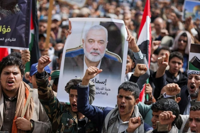 a demonstrator holds up a poster of assassinated hamas chief ismail haniyeh outside the un offices in sanaa yemen august 3 2024 photo reuters a demonstrator holds up a poster of assassinated hamas chief ismail haniyeh outside the un offices in sanaa yemen august 3 2024 photo reuters