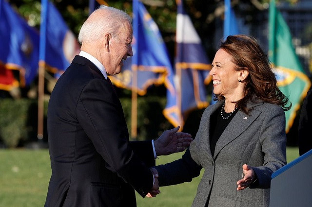 us president joe biden and vice president kamala harris shake hands during a ceremony to sign the infrastructure investment and jobs act on the south lawn at the white house in washington u s november 15 2021 photo reuters