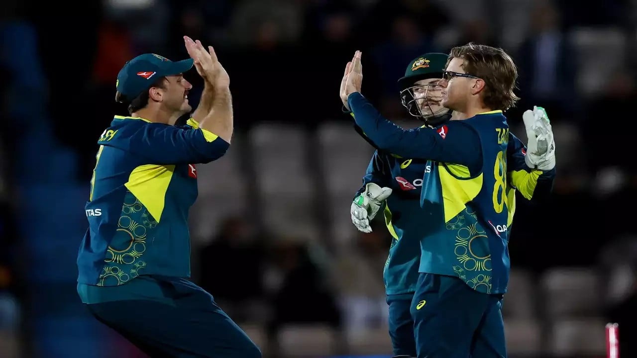 australia s adam zampa celebrates with teammates after taking the wicket of england s jaimie overton photo afp