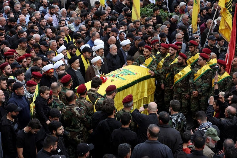 Mourners gather near the coffin of Hezbollah member Jaafar Serhan, who was killed while deployed in Syria with Hezbollah, during his funeral in Mashghara, Lebanon November 13, 2023. PHOTO: REUTERS