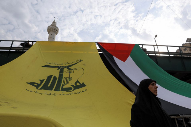 a woman looks on as hezbollah supporters protest in solidarity with palestinians in gaza beirut lebanon october 27 2023 photo reuters a woman looks on as hezbollah supporters protest in solidarity with palestinians in gaza beirut lebanon october 27 2023 photo reuters
