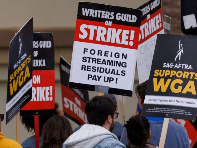 members of sag aftra and the writers guild of america walk the picket line outside paramount studios in los angeles california u s june 7 2023 photo reuters