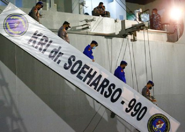 indonesian police officers walk down the stairs of the ship kri dr soeharso 990 at tanjung wangi port as the search continues for the missing kri nanggala 402 submarine in banyuwangi east java province indonesia april 23 2021 photo reuters