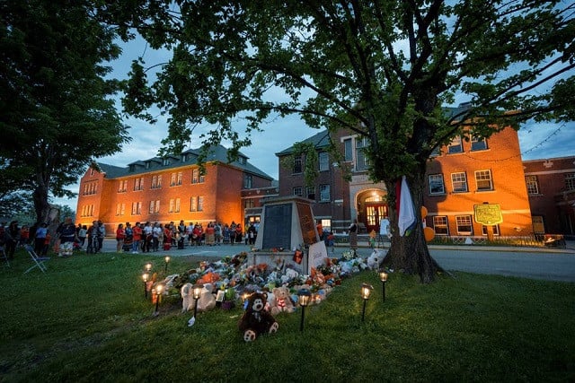 kamloops residents and first nations people gather to listen to drummers and singers at a memorial in front of the former kamloops indian residential school after the remains of 215 children some as young as three years old were found at the site last week in kamloops british columbia canada may 31 2021 photo reuters