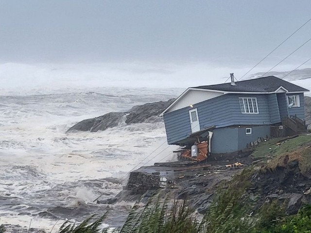 waves roll in near a damaged house built close to the shore as hurricane fiona later downgraded to a post tropical cyclone passes the atlantic settlement of port aux basques newfoundland and labrador canada september 24 2022 courtesy of wreckhouse press handout via reuters