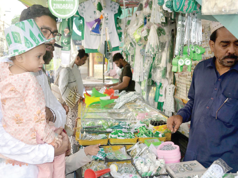 a man buys independence day items for his child from a stall in hyderabad photo nni