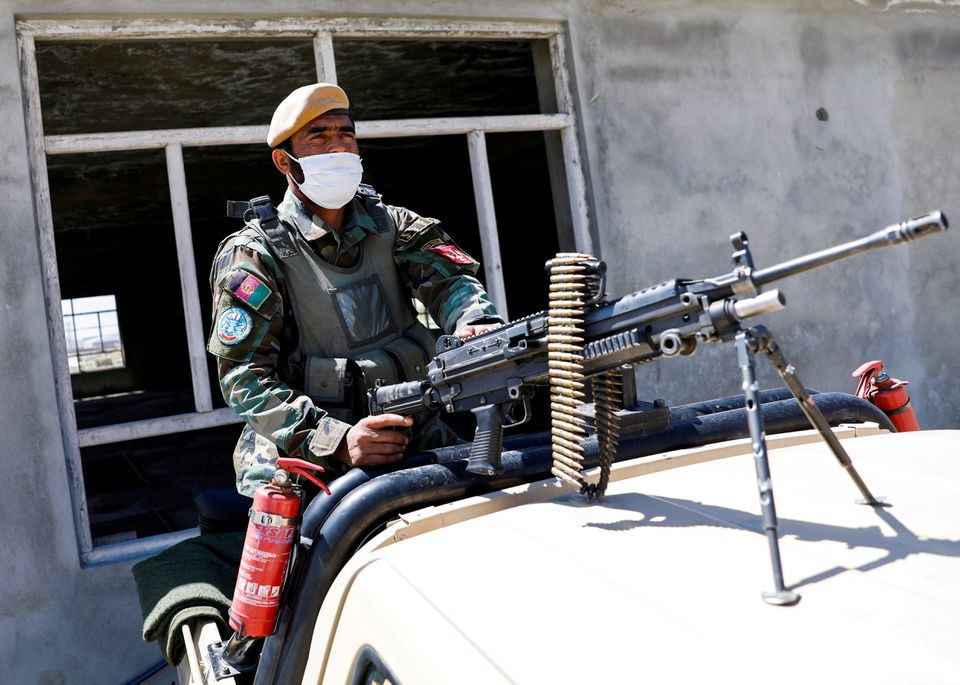 an afghan national army soldier sits on a back of an army vehicle at a checkpoint on the outskirts of kabul afghanistan april 21 2021 reuters