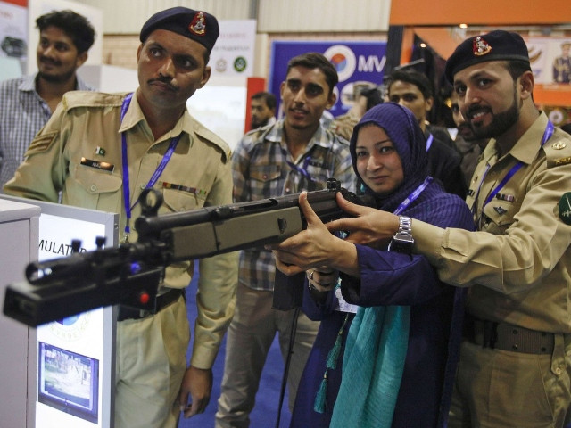 a visitor aims a simulation gun at a target during the international defence exhibition and seminar in karachi pakistan photo file reuters