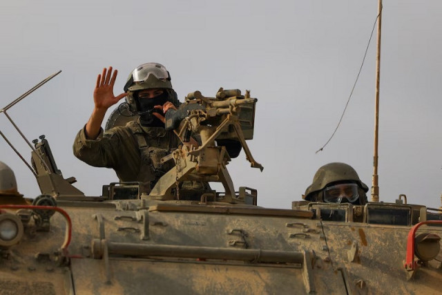 israeli military personnel drive an armoured personnel carrier apc near the israel gaza border as seen from israel april 3 2024 photo reuters israeli military personnel drive an armoured personnel carrier apc near the israel gaza border as seen from israel april 3 2024 photo reuters