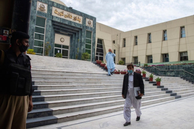a lawyer walks past in front of the peshawar high court building photo afp a lawyer walks past in front of the peshawar high court building photo afp