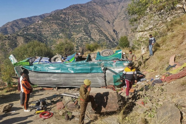 a police personnel attends a phone call near the wrecked bus in the doda area about 200 kilometres southeast of the srinagar photo afp a police personnel attends a phone call near the wrecked bus in the doda area about 200 kilometres southeast of the srinagar photo afp