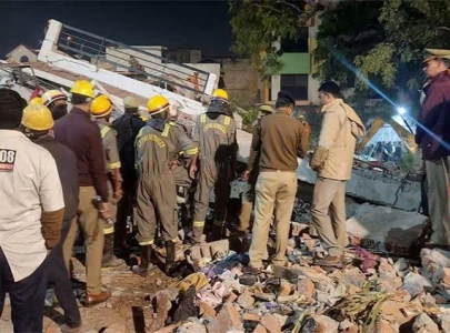 twelve rescued after building collapses in india more feared trapped