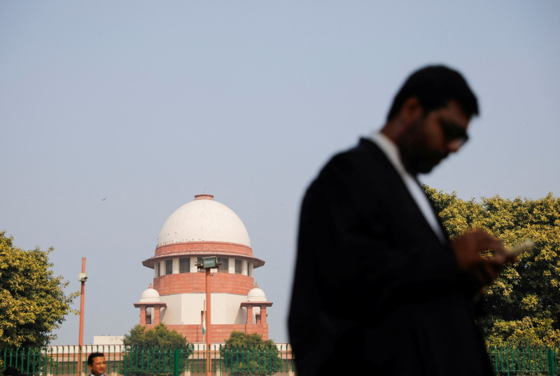 a lawyer looks into his mobile phone in front india s supreme court in new delhi december 11 2023 photo reuters