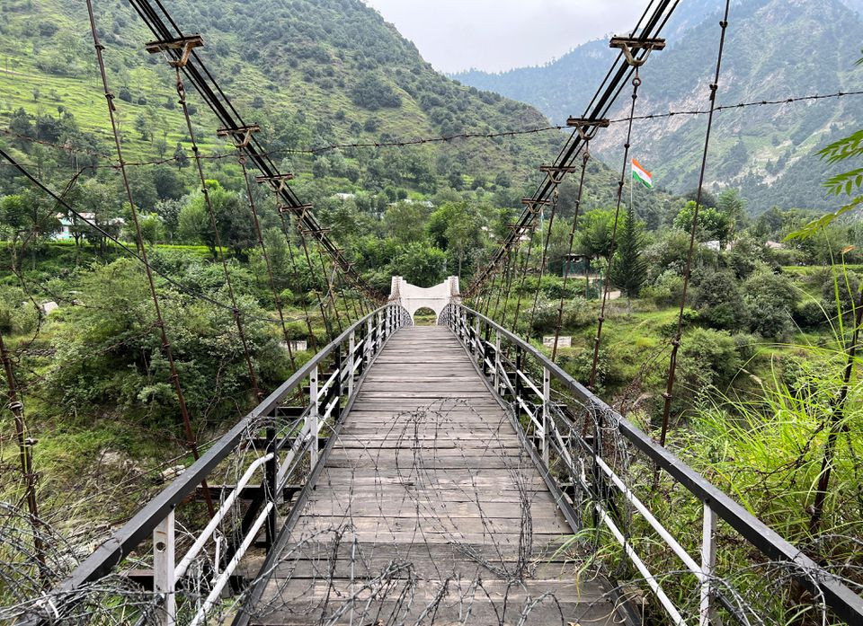 a general view of a bridge between pakistan and india closed since 2018 with an indian flag in the background in chilehana pakistan india crossing point in kashmir pakistan august 11 2022 reuters