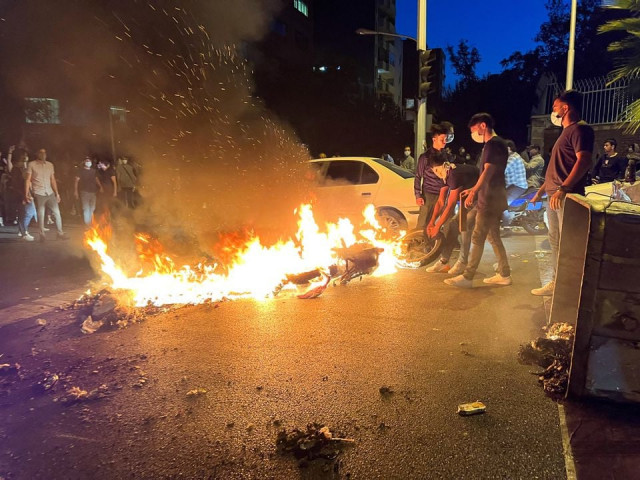 a police motorcycle burns during a protest over the death of mahsa amini a woman who died after being arrested by the islamic republic s morality police in tehran iran september 19 2022 photo reuters a police motorcycle burns during a protest over the death of mahsa amini a woman who died after being arrested by the islamic republic s morality police in tehran iran september 19 2022 photo reuters