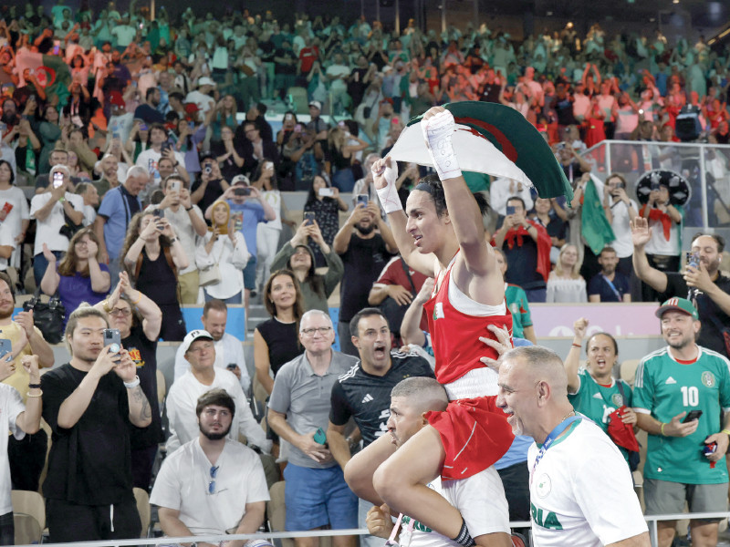 imane khelif of algeria holds an algerian flag as she celebrates winning the final and gold medal against liu yang of china photo reuters