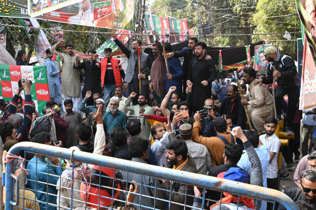 pti workers chant slogans outside the residence of party chief imran khan in lahore photo afp pti workers chant slogans outside the residence of party chief imran khan in lahore photo afp