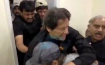 former prime minister imran khan is helped after he was shot in the shin in wazirabad pakistan november 3 2022 screengrab