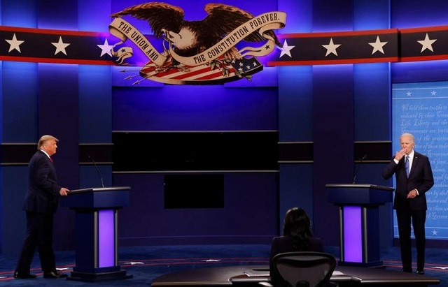 us president donald trump and democratic presidential nominee joe biden arrive on stage to participate on their final 2020 us presidential campaign debate at belmont university in nashville tennessee us october 22 2020 photo reuters