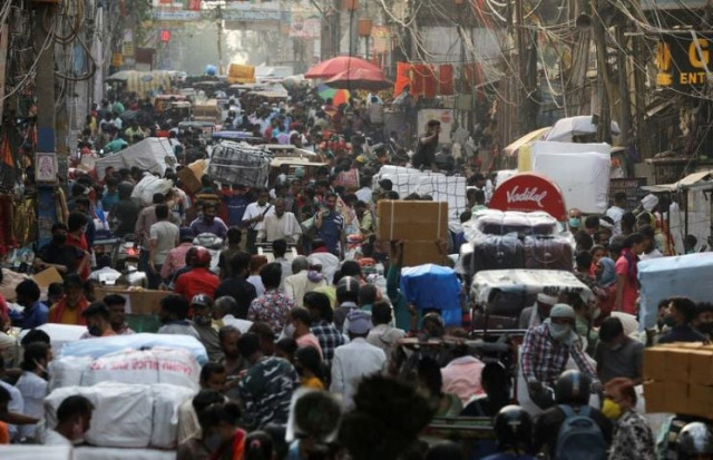 people walk at a crowded market amidst the spread of the coronavirus disease in the old quarters of delhi india photo reuters