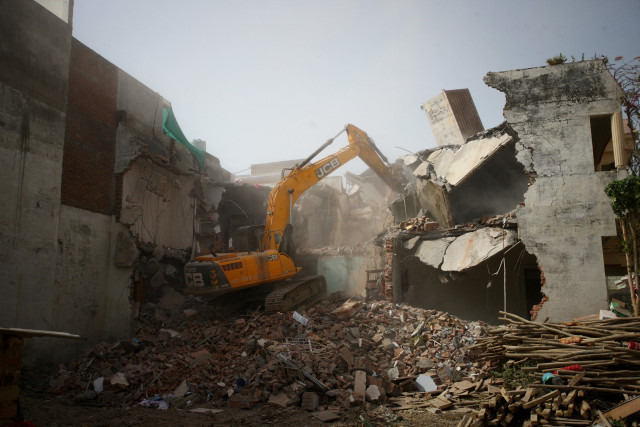 brute force indian security personnel keep vigil as a bulldozer demolishes the house of a muslim man who participated in the recent protests against bjp s official s incendiary remarks in prayagraj on sunday photo reuters brute force indian security personnel keep vigil as a bulldozer demolishes the house of a muslim man who participated in the recent protests against bjp s official s incendiary remarks in prayagraj on sunday photo reuters