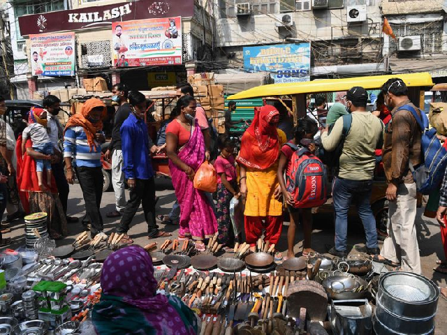 people wearing facemasks as a preventive measure against the covid 19 coronavirus crowd in a market area in the old quarters of new delhi on october 11 2020 photo afp