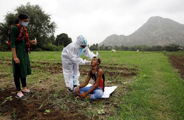healthcare worker hemaben raval collects a swab for a rapid antigen test from farmer vinod vajabhai dabhi in his field during a door to door vaccination drive amid the ongoing coronavirus disease covid 19 outbreak in banaskantha district in the western state of gujarat india july 23 2021 photo reuters healthcare worker hemaben raval collects a swab for a rapid antigen test from farmer vinod vajabhai dabhi in his field during a door to door vaccination drive amid the ongoing coronavirus disease covid 19 outbreak in banaskantha district in the western state of gujarat india july 23 2021 photo reuters