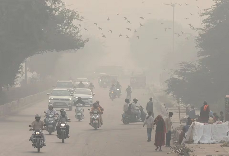 people and vehicles are seen on a road amidst the morning smog in new delhi india november 8 2023 photo reuters