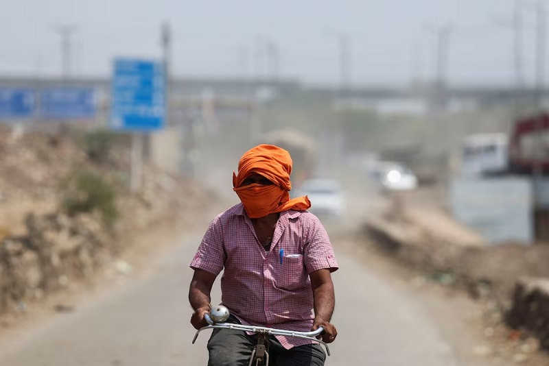 a man rides his cycle near a landfill site on a hot summer day during a heatwave in new delhi india may 27 2024 photo reuters