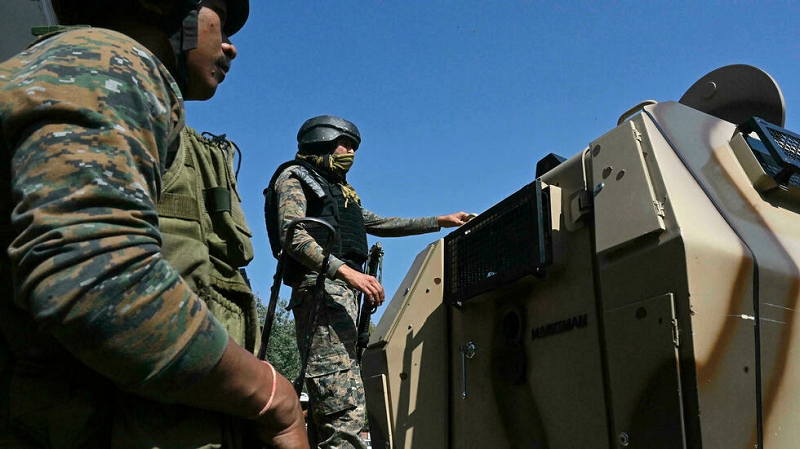 in a file photo indian paramilitary troops stand guard on the outskirts of iiojk s srinagar photo afp