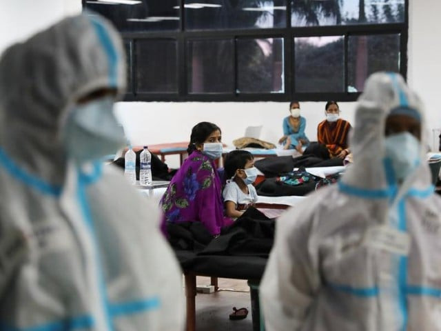 a woman sits with her child inside a quarantine centre for the coronavirus disease covid 19 patients amidst the spread of the disease at an indoor sports complex in new delhi september 22 2020 photo reuters file a woman sits with her child inside a quarantine centre for the coronavirus disease covid 19 patients amidst the spread of the disease at an indoor sports complex in new delhi september 22 2020 photo reuters file