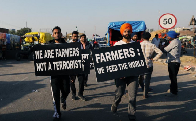 file photo farmers carry placards at a site of a protest against the newly passed farm bills at singhu border near delhi india november 28 2020 photo reuters file photo farmers carry placards at a site of a protest against the newly passed farm bills at singhu border near delhi india november 28 2020 photo reuters