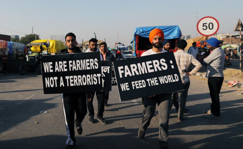 file photo farmers carry placards at a site of a protest against the newly passed farm bills at singhu border near delhi india november 28 2020 photo reuters